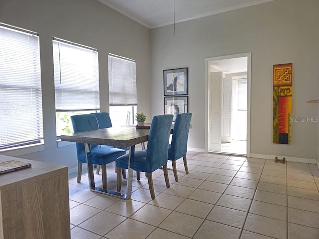 tiled dining area featuring crown molding