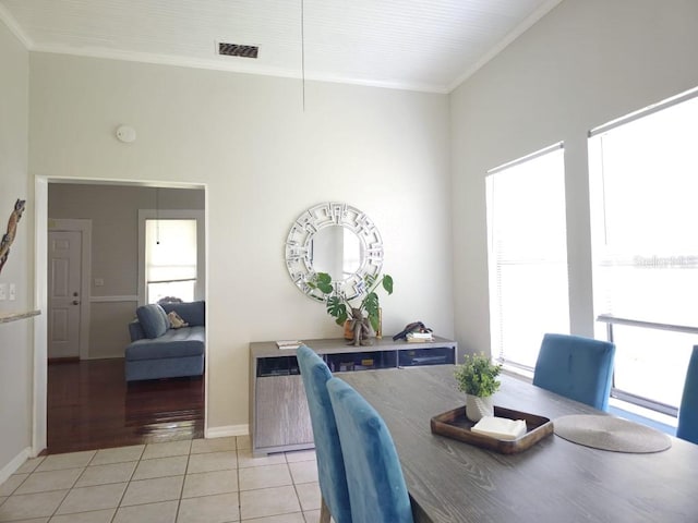 dining room featuring ornamental molding, light hardwood / wood-style flooring, and plenty of natural light