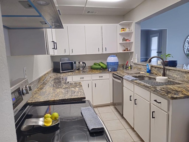 kitchen featuring appliances with stainless steel finishes, white cabinetry, kitchen peninsula, range hood, and sink