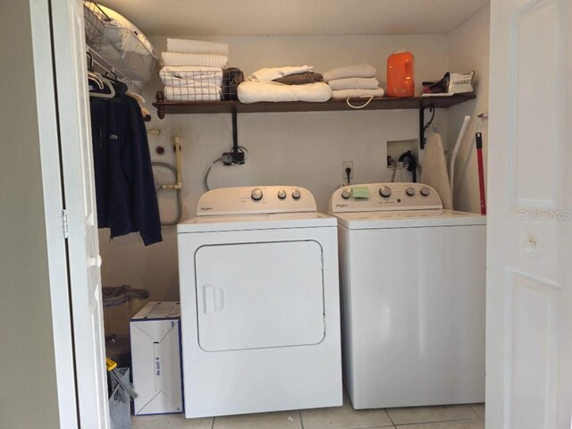 washroom featuring separate washer and dryer and light tile patterned flooring