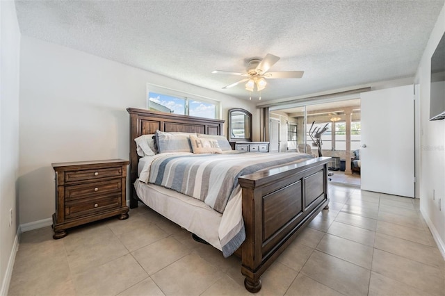 tiled bedroom with ceiling fan, a textured ceiling, and access to outside