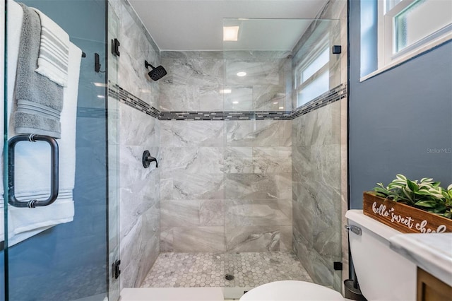 bathroom featuring toilet and an enclosed shower