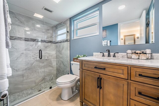 3849 Claremont Dr, New Port Richey, FL 34652 - bathroom featuring toilet, vanity, a stall shower, and tile patterned floors