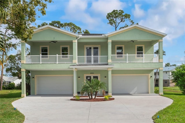 view of front of property with a garage, ceiling fan, and covered porch