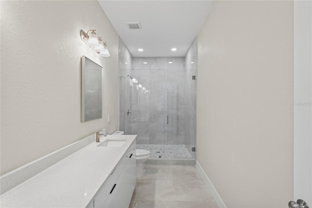 bathroom featuring a shower with door, vanity, and toilet