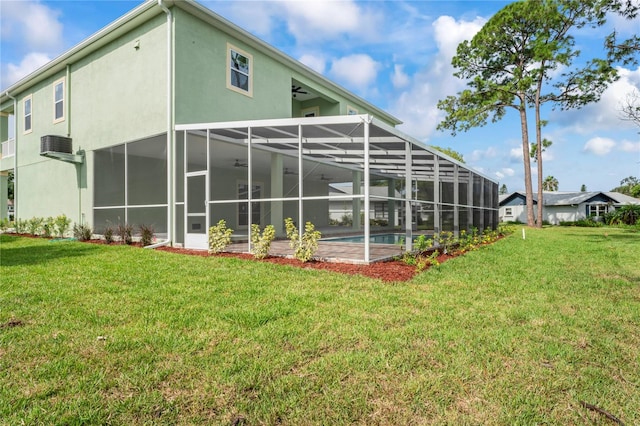 rear view of house featuring a lanai and a yard