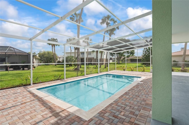 view of pool with a lawn, a lanai, and a patio area