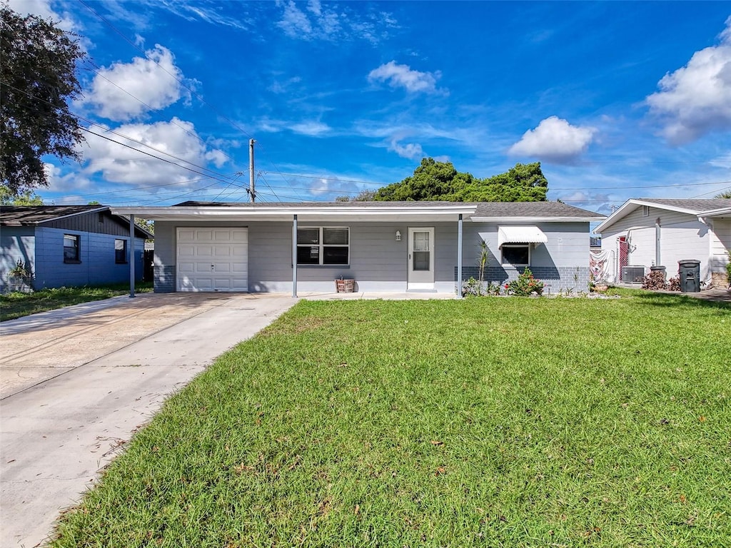 ranch-style home with a garage and a front lawn