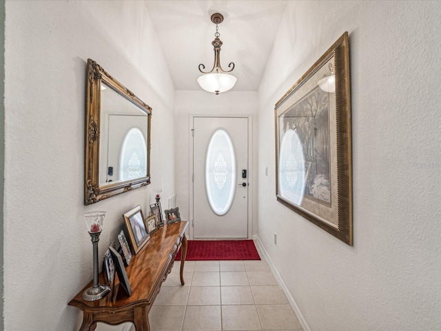 foyer featuring lofted ceiling and light tile patterned floors