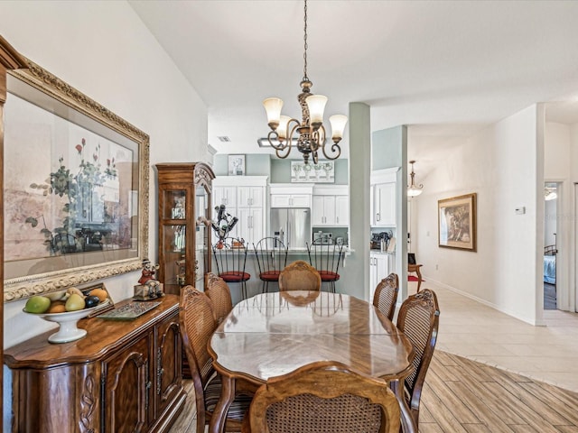 dining room with a notable chandelier and light tile patterned floors