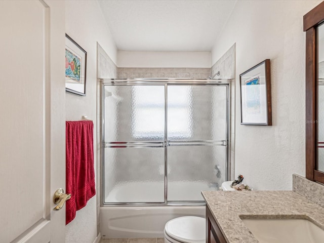 full bathroom featuring shower / bath combination with glass door, vanity, and toilet