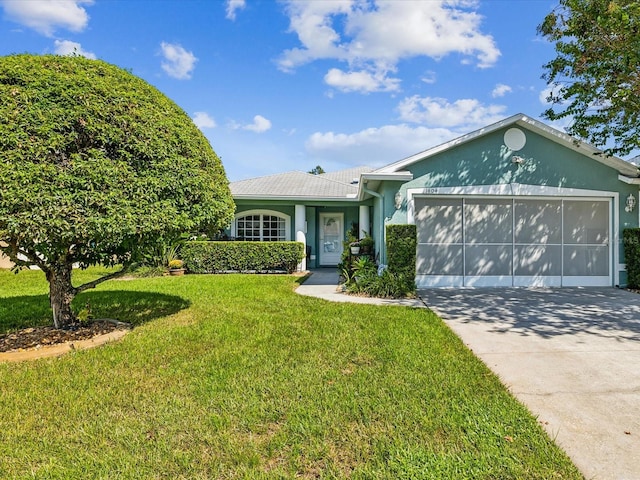 view of front of property featuring a garage and a front lawn