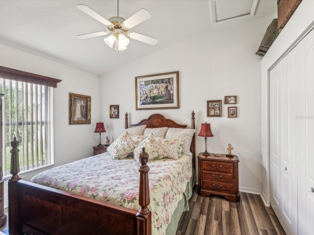 bedroom with ceiling fan, a closet, dark hardwood / wood-style flooring, and lofted ceiling