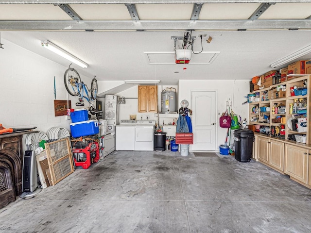 garage featuring washer and clothes dryer, water heater, and a garage door opener