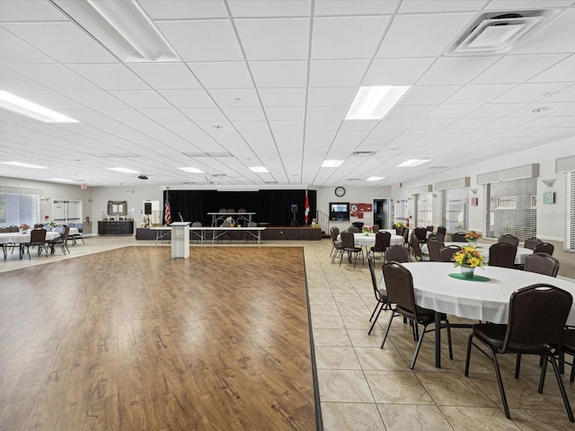 dining room featuring wood-type flooring and a paneled ceiling