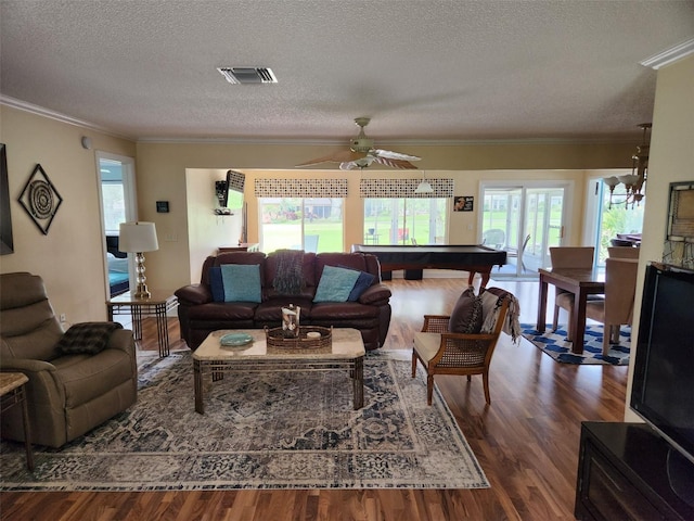 living room with ceiling fan, a textured ceiling, dark wood-type flooring, pool table, and crown molding