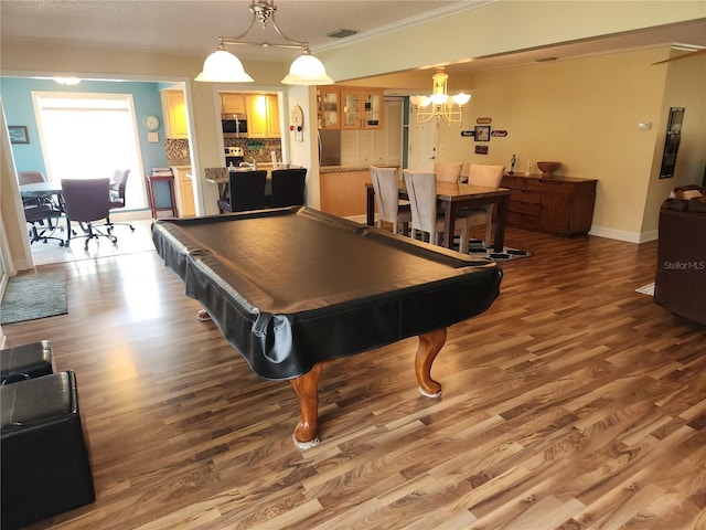 recreation room with ornamental molding, wood-type flooring, and billiards