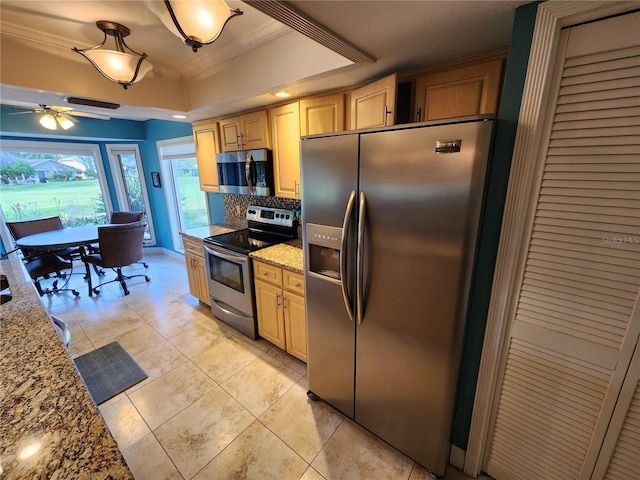 kitchen with decorative backsplash, crown molding, light stone countertops, and stainless steel appliances