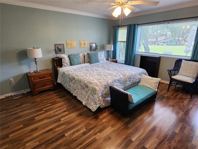 bedroom with crown molding, dark wood-type flooring, and ceiling fan