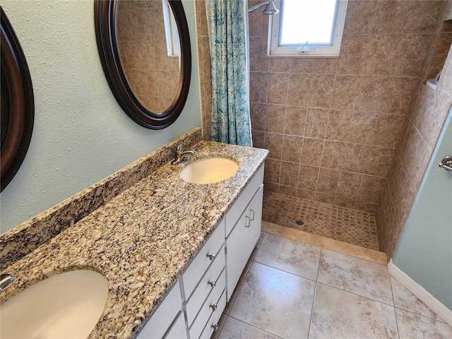 bathroom with tile patterned flooring, a shower with curtain, and vanity