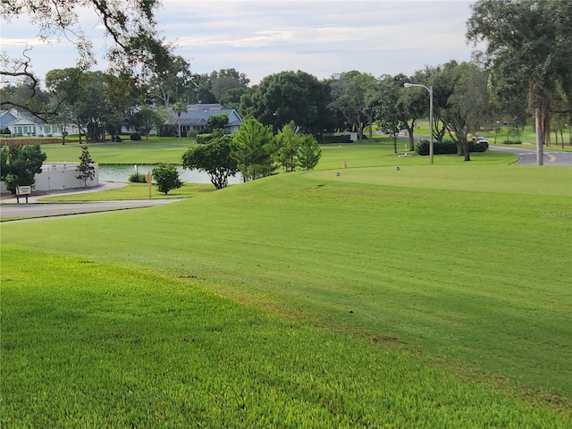 view of property's community featuring a water view and a yard