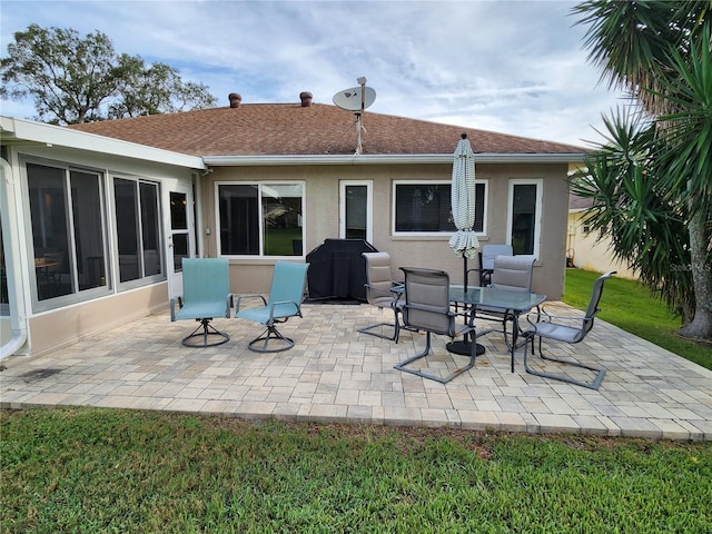 rear view of house featuring a yard and a patio