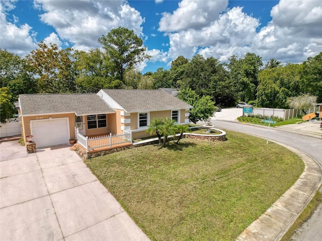 ranch-style home with a garage, a porch, and a front lawn