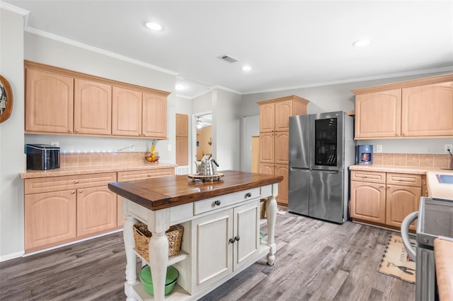 kitchen featuring crown molding, stainless steel fridge, and light brown cabinets