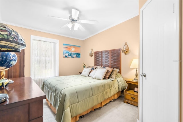 carpeted bedroom featuring ceiling fan and ornamental molding