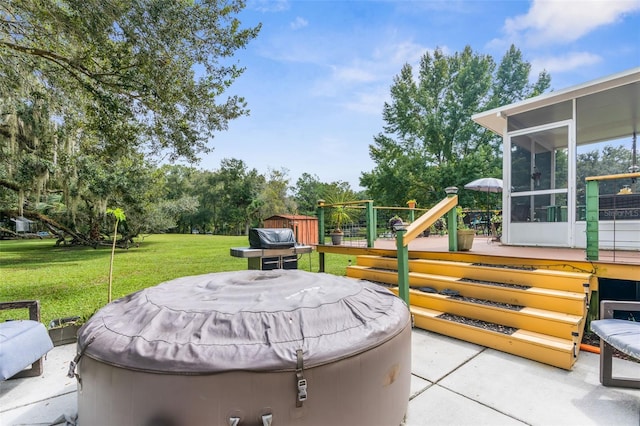 view of patio / terrace with a hot tub and a sunroom