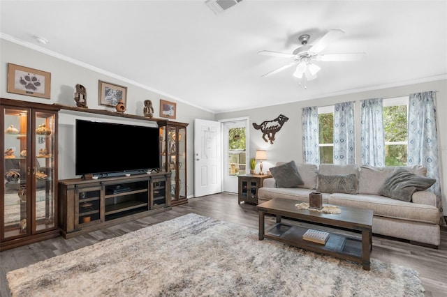 living room with crown molding, ceiling fan, and dark hardwood / wood-style floors