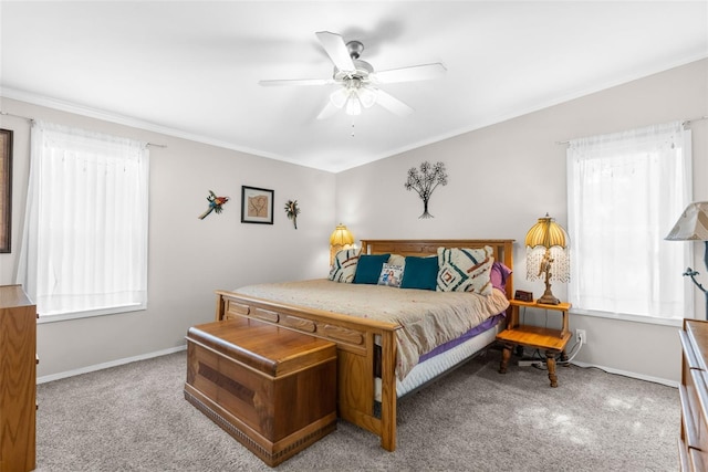 carpeted bedroom featuring crown molding, ceiling fan, and multiple windows