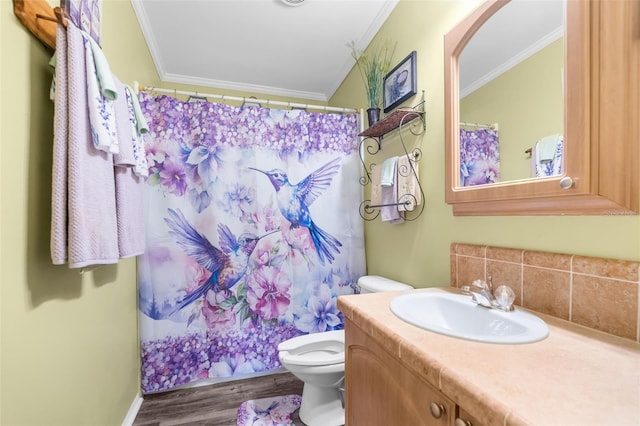 bathroom with vanity, wood-type flooring, ornamental molding, curtained shower, and toilet