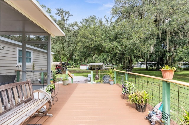 wooden deck featuring a lawn