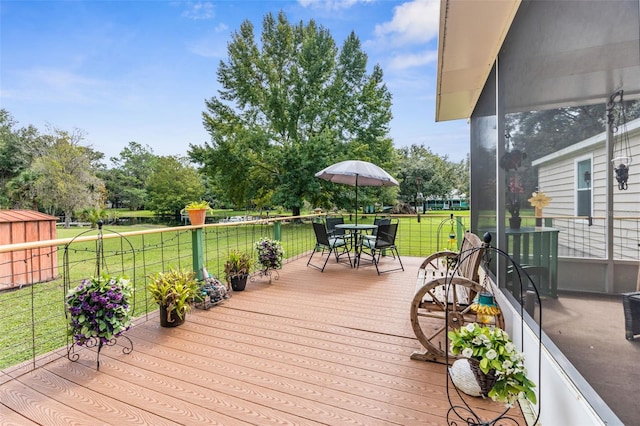 wooden terrace featuring a lawn