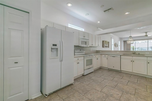 kitchen featuring white appliances, white cabinetry, sink, and pendant lighting