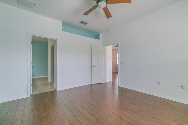 spare room featuring wood-type flooring and ceiling fan