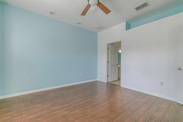 empty room featuring ceiling fan and hardwood / wood-style floors