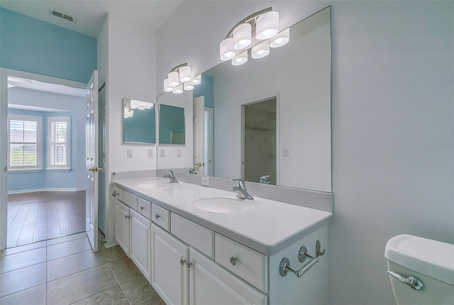 bathroom featuring hardwood / wood-style floors, vanity, and toilet