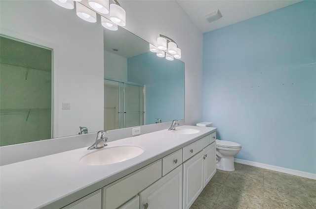 bathroom with a shower with door, vanity, and toilet