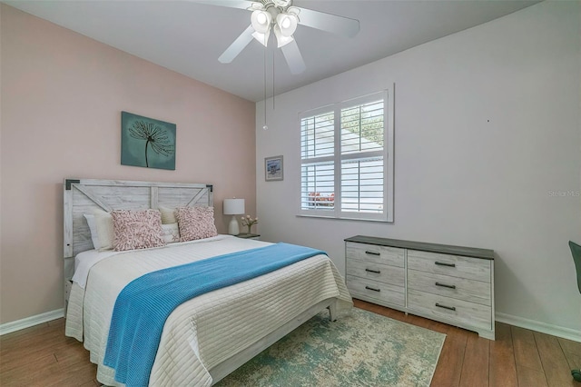 bedroom featuring ceiling fan and dark wood-type flooring