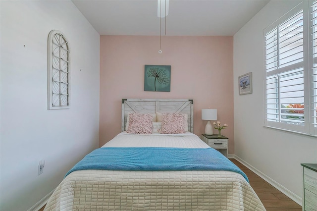 bedroom featuring multiple windows and hardwood / wood-style flooring