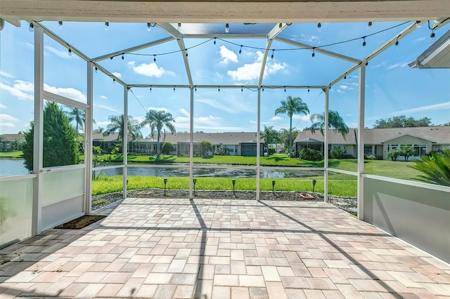 unfurnished sunroom with a water view