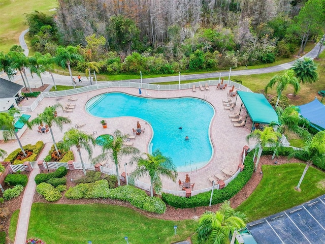 view of swimming pool featuring a yard and a patio