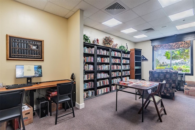 carpeted office with a paneled ceiling