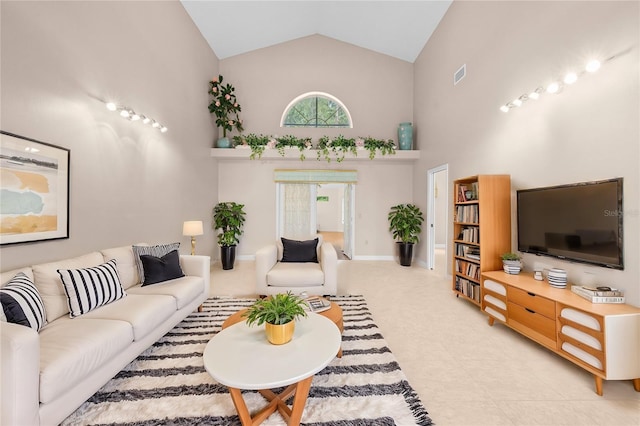 living room featuring high vaulted ceiling