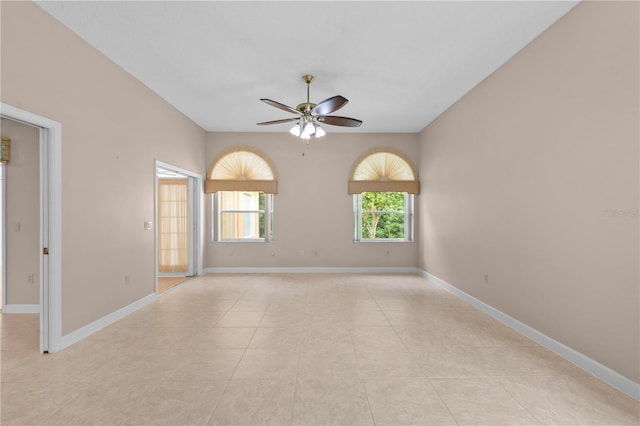 tiled empty room with ceiling fan