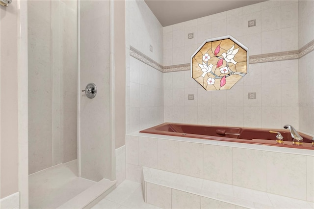 bathroom featuring shower with separate bathtub, tile walls, and tile patterned flooring