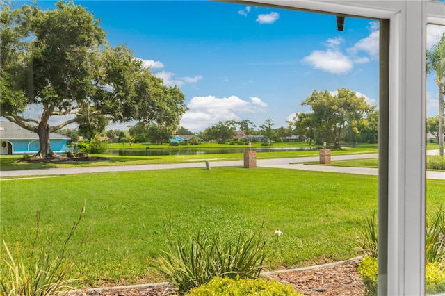 surrounding community with a lawn and a water view