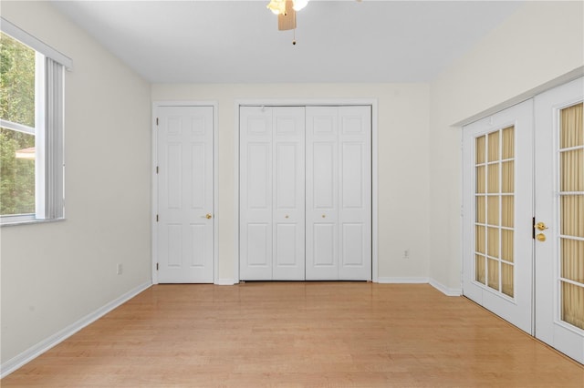 unfurnished bedroom with ceiling fan, light hardwood / wood-style flooring, and french doors